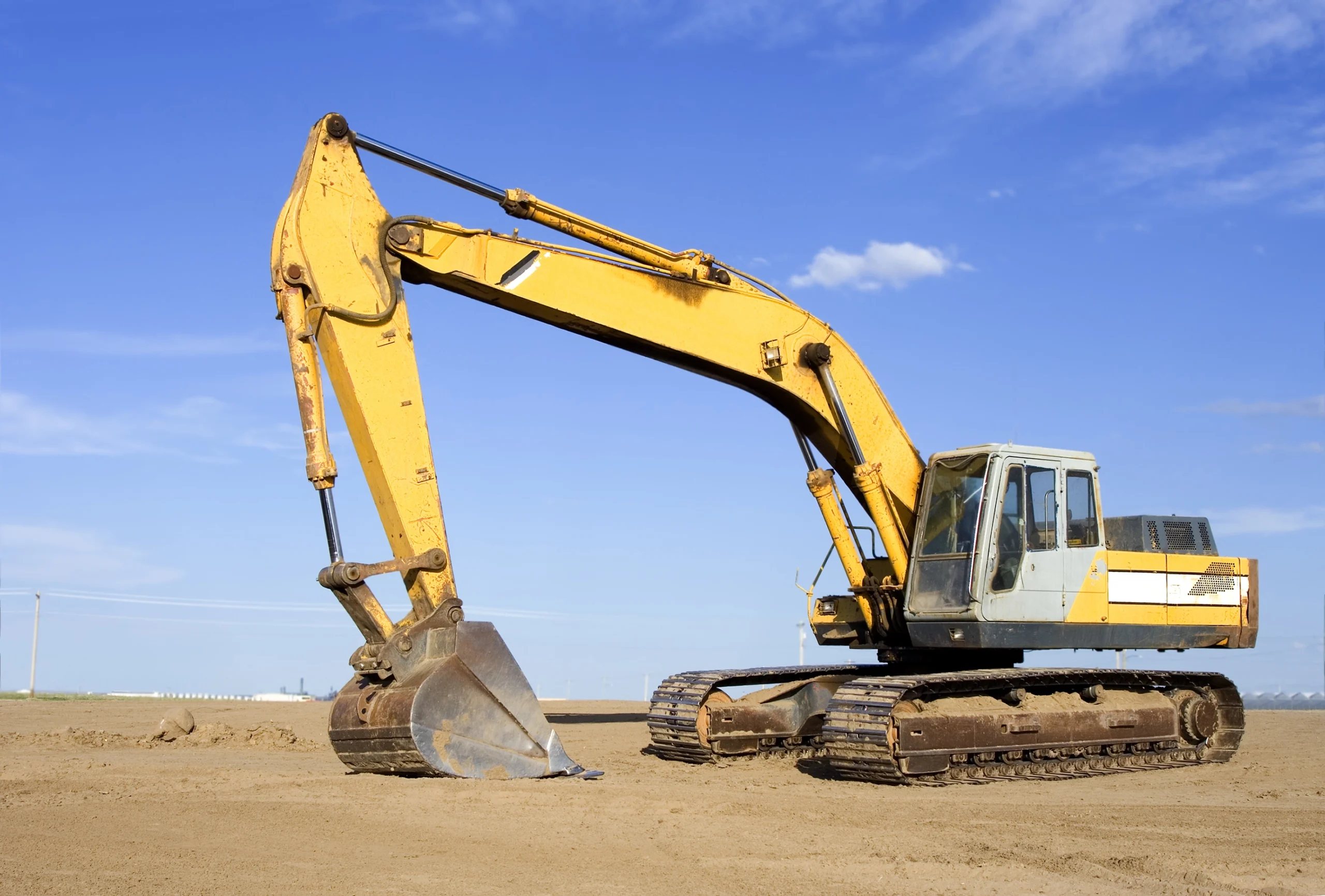 A yellow machine on a construction site on a nice, sunny day.