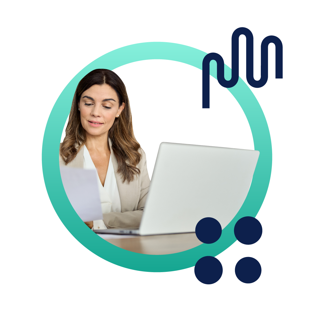 A business woman in a tan suit reading a document and sitting at her desk in front of a computer, inside of a designed green circle.