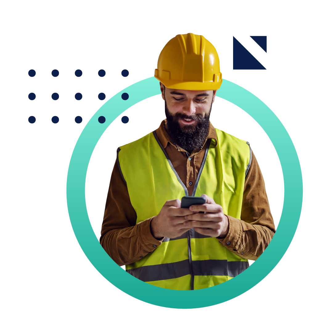 A man in a hard hat and construction vest looking at his phone on a job site. The image is placed inside a green circle.