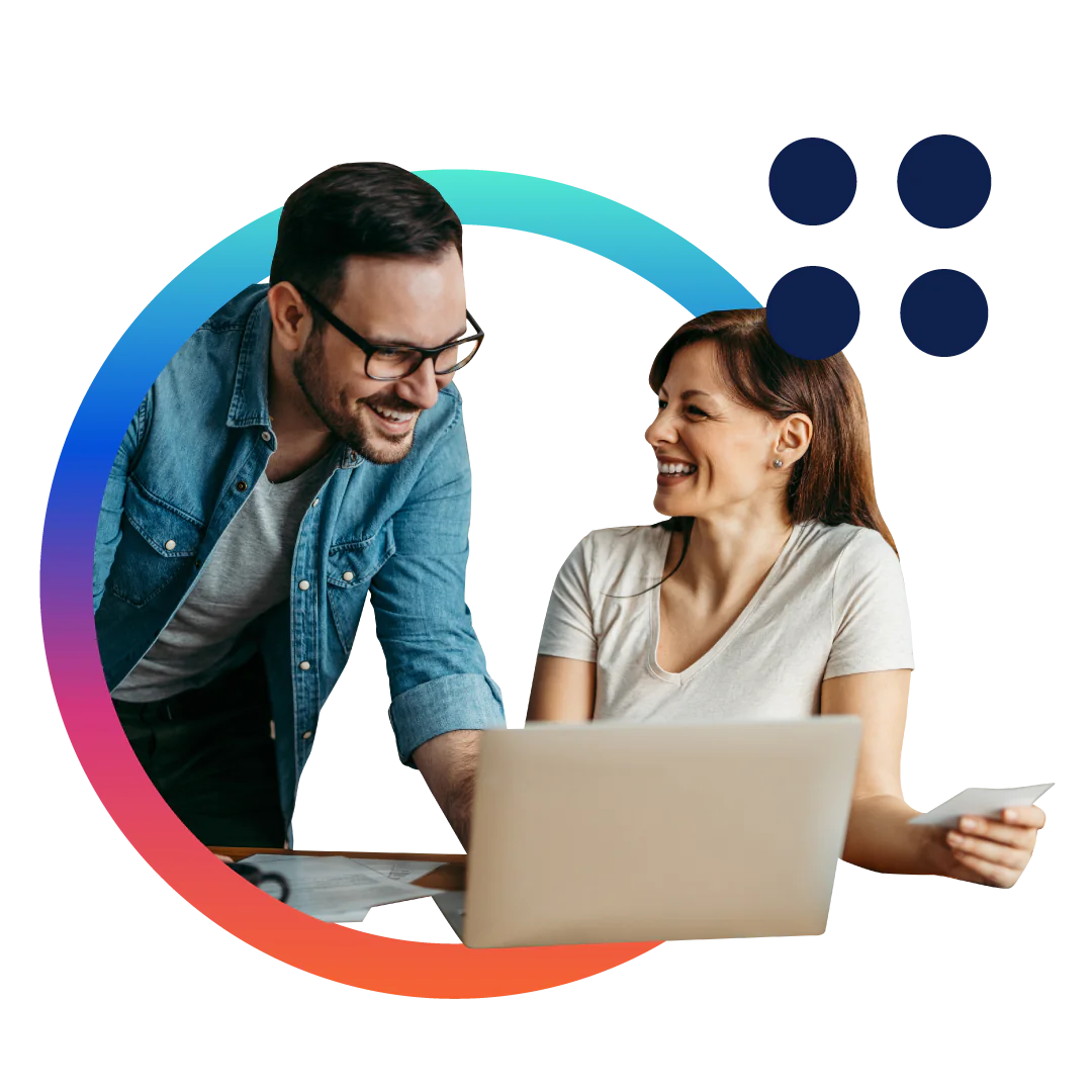 A business man in a blue buttoned shirt looks at a document while sitting at his desk in front of a computer, all placed inside of a designed green circle.