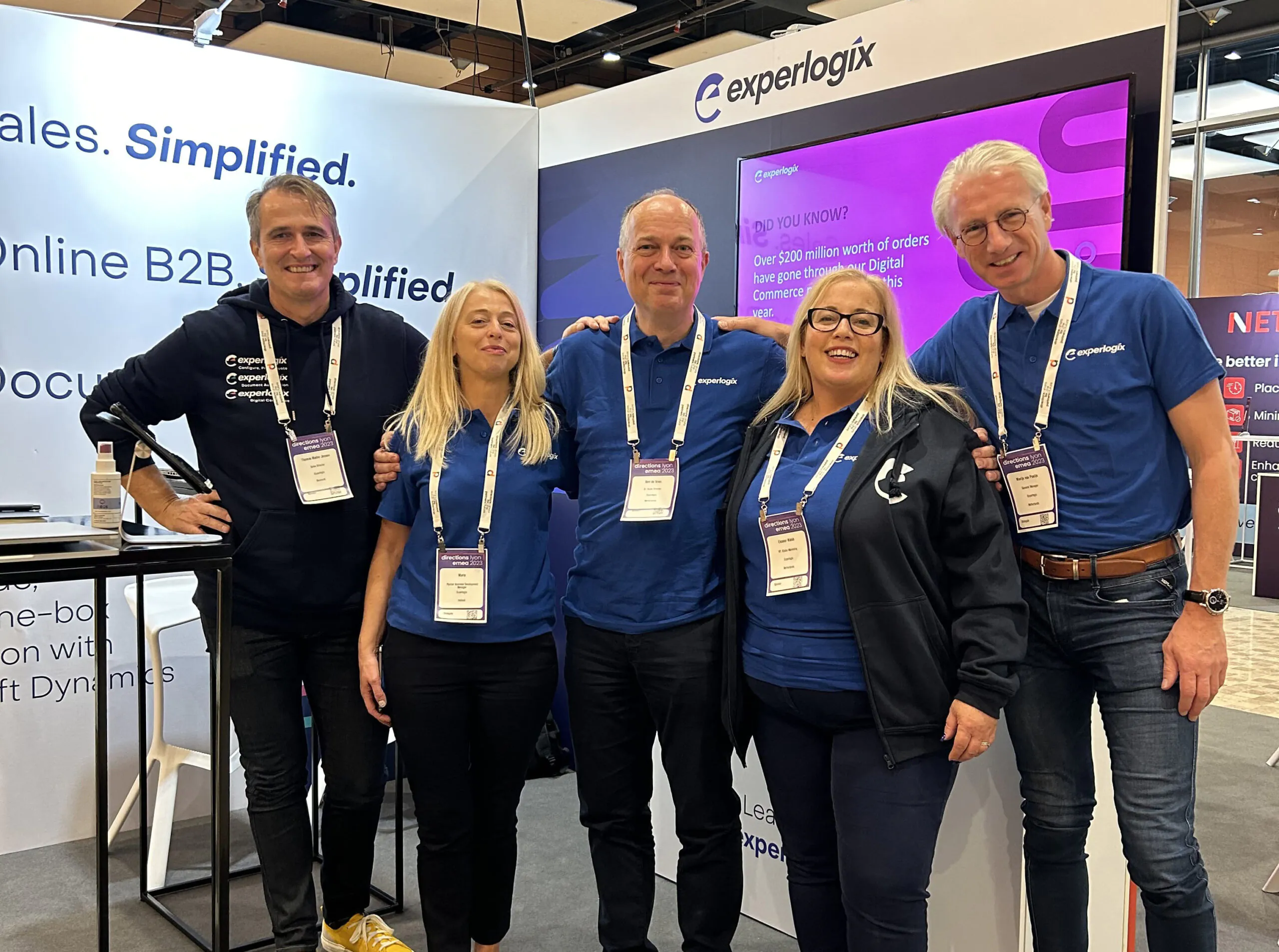 A business woman smiling and writing on a document while working at her desk on a laptop, all placed inside of a designed green circle.