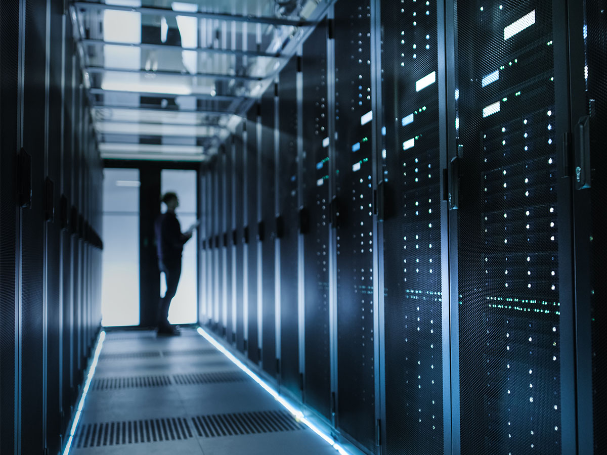 Consolidating-Customer-Information-Better-CX A man standing in a data center