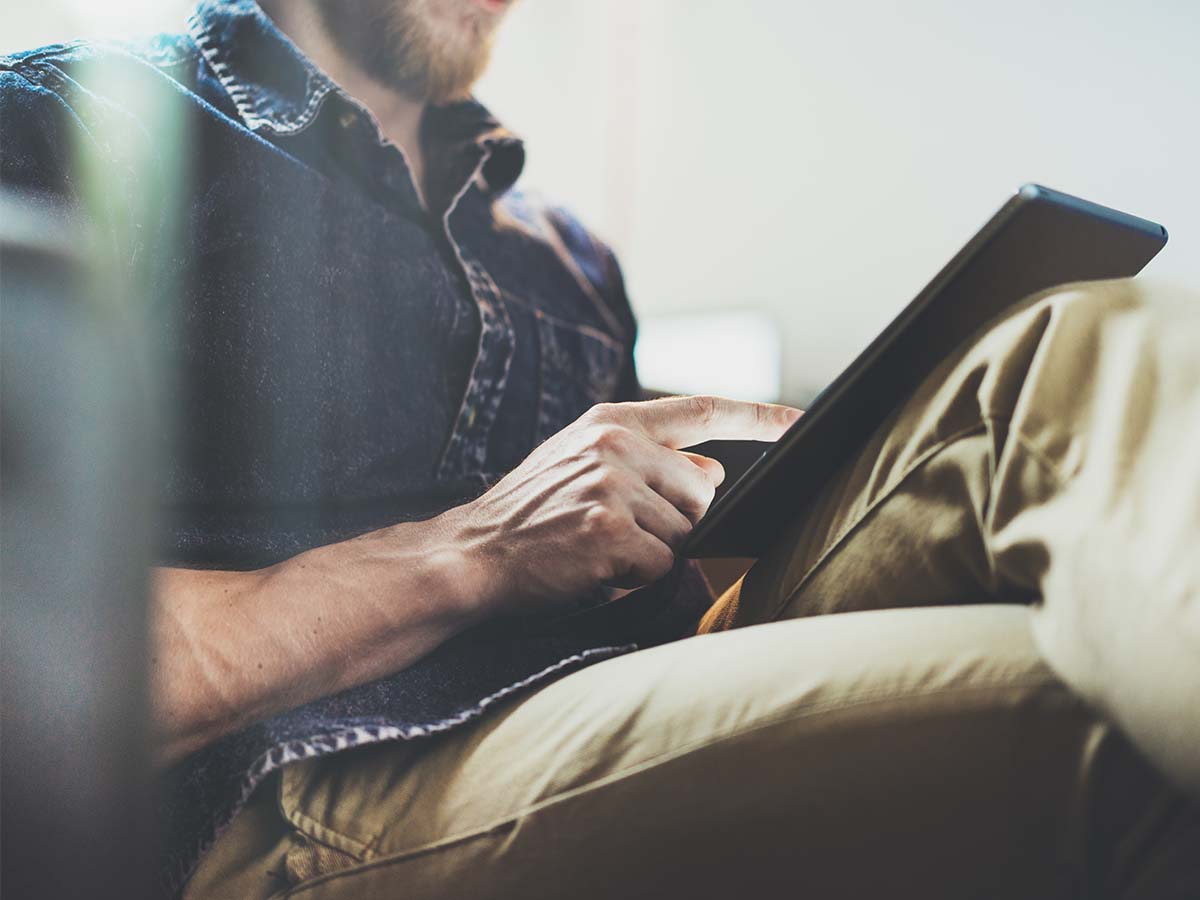 Five-Tips-for-Designing-Effective-Document-Templates-that-will-Improve-Customer-Communications A man using a tablet.