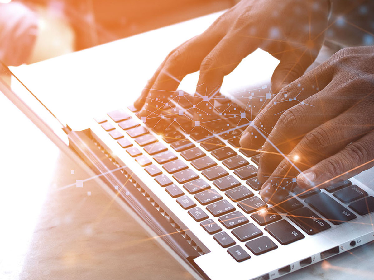 How-Experlogix-Document-Automation-Smart-Flows-Boosts-Power-Automate-Capabilities A man typing on a laptop.