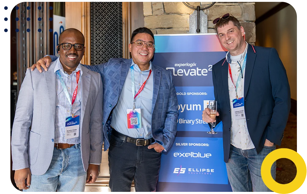 Experlogix employee and partners posing and smiling at a conference.