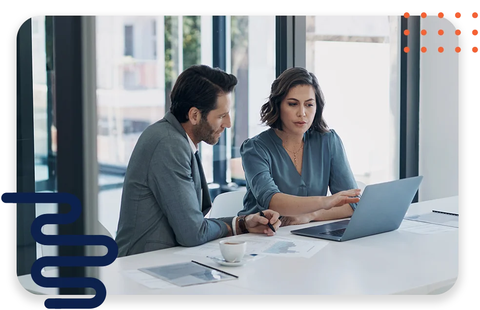 CPQ-Photo-with-two-patterns-three-modules2 An office with cool lighting and business coworkers sitting at a table in a meeting.