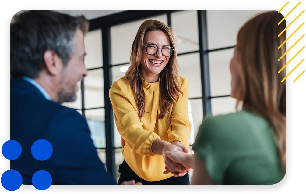 Business meeting with partners and clients, smiling and shaking hands.