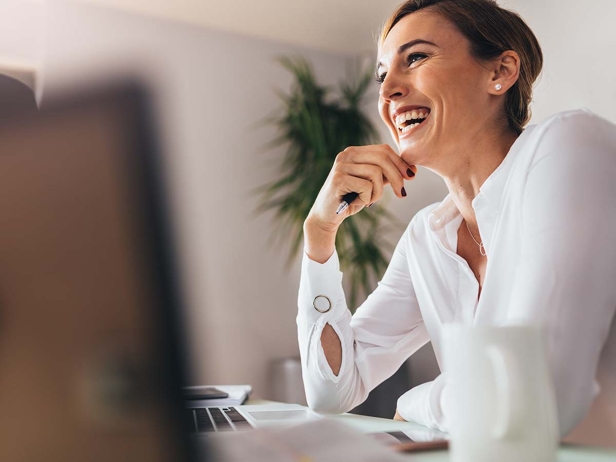 Stop-Struggling-with-SSRS-Reports-Experlogix-Document-Automation-Smart-Flows-for-Dynamics A business woman smiling in her office.