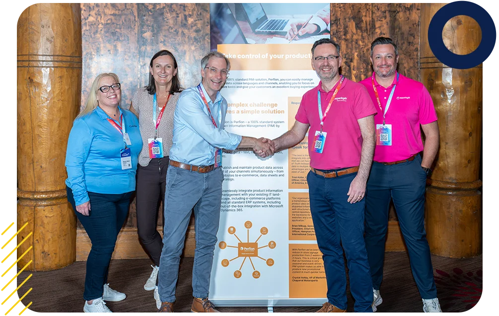 Experlogix employees shaking hands with clients at an event.