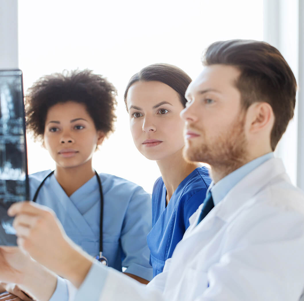 coverys_experlogix_document_automation A group of medical professionals reading an xray.