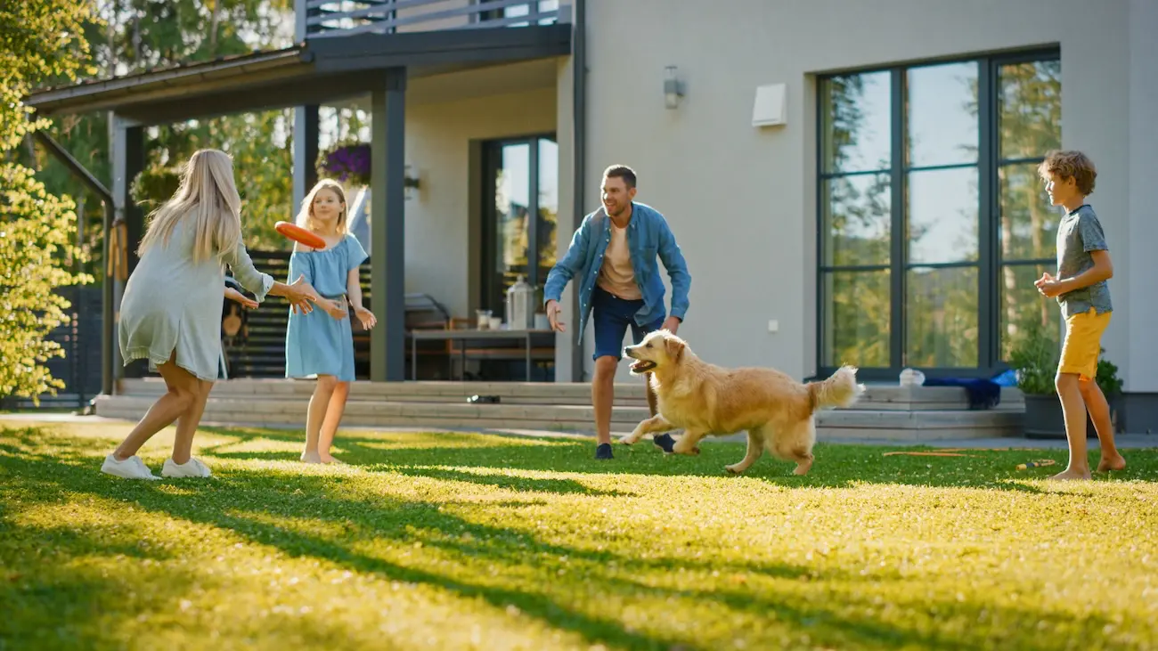 london-quadrant_experlogix_document_automation_microsfot_dynamic_CRM A family and dog playing frisbee in a yard.